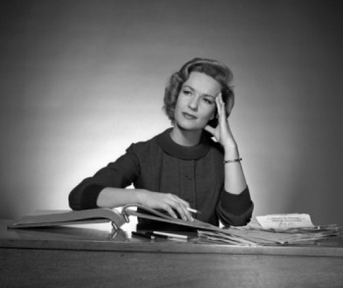 Woman sitting at desk reading book Poster Print - Item # VARSAL25528040B