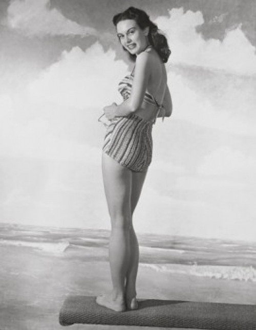 Young woman standing on a beach mat and smiling Poster Print - Item # VARSAL2552823B