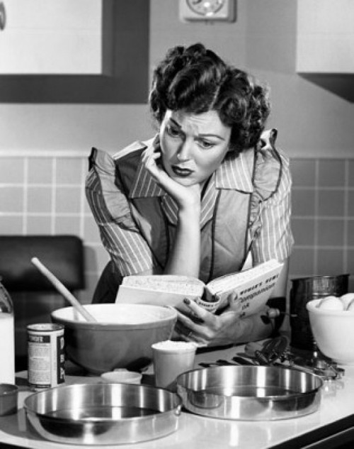 Mid adult woman reading a cookbook in a domestic kitchen Poster Print - Item # VARSAL2552830B