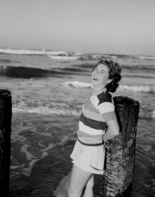 Mid-adult woman leaning against breakwater Poster Print - Item # VARSAL255423325