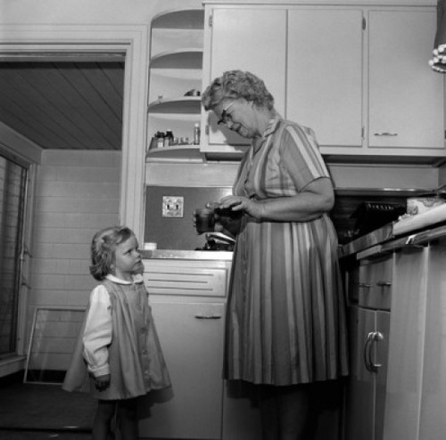 Grandmother preparing drink for granddaughter in kitchen Poster Print - Item # VARSAL255416395
