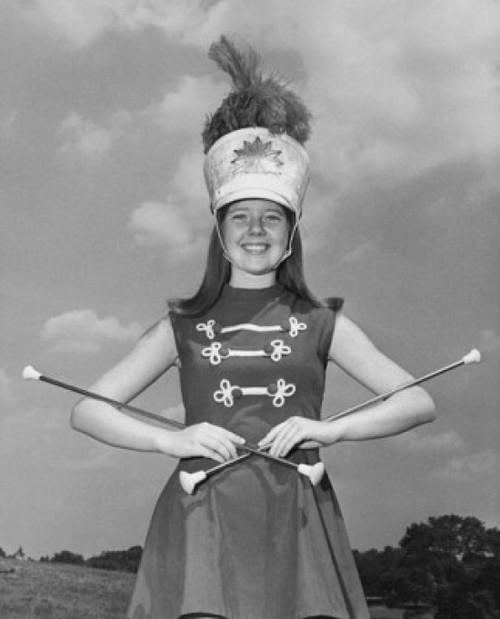 Drum majorette performing with two twirling batons and smiling Poster Print - Item # VARSAL25524693B