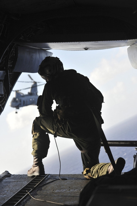 December 4, 2011 - U.S. Marine looks out the back of a CH-46E Sea Knight over the Pacific Ocean Poster Print - Item # VARPSTSTK105238M
