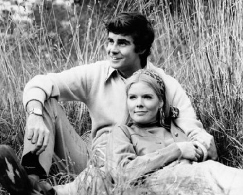 Young couple resting in a field Poster Print - Item # VARSAL25525674