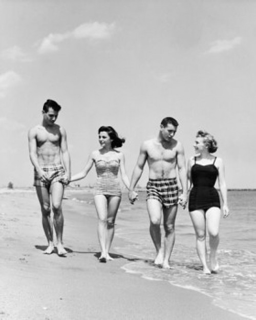 Two young couples walking on beach Poster Print