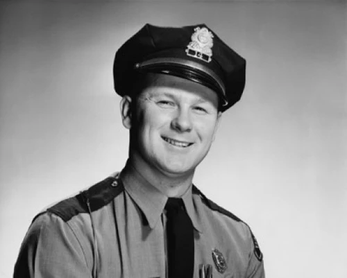 Portrait of a policeman smiling Poster Print