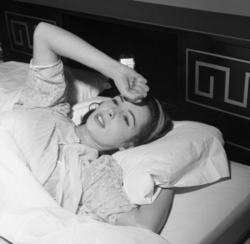 Young woman lying in bed with hand on forehead Poster Print - Item # VARSAL255417388