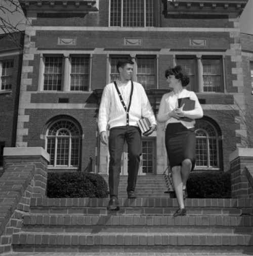 Young couple on steps outside university Poster Print - Item # VARSAL255418384