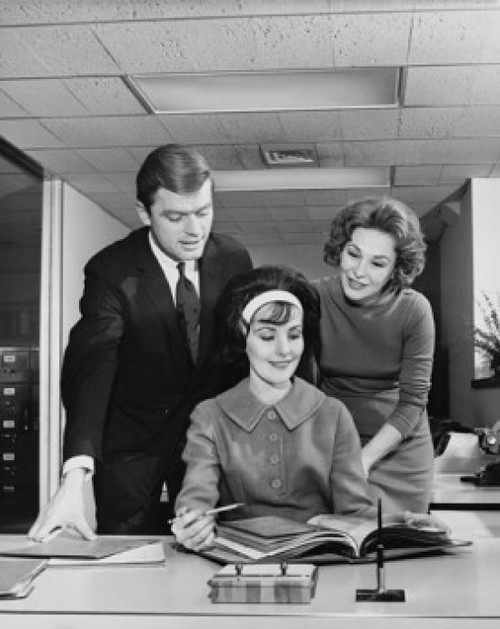 Two businesswomen and a businessman looking at a file in an office Poster Print - Item # VARSAL25543611A