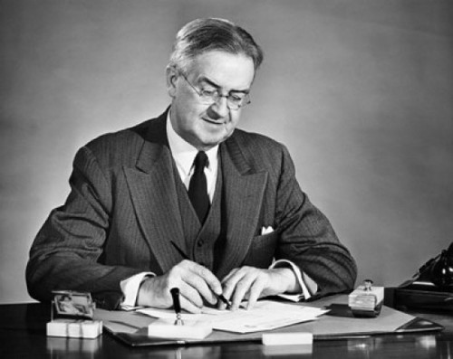 Businessman writing on a sheet of paper and smiling Poster Print - Item # VARSAL25528013