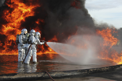 December 7, 2011 - Aircraft Rescue and Firefighting Marines push forward continuing to fight back the flames of a training fire during a pit fuel fires training exercise at the burn pit Poster Print - Item # VARPSTSTK105242M