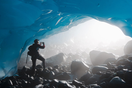 A Hiker Takes A Photograph Of The Entrance Of An Ice Cave From The Inside Of The Mendenhall Glacier, Juneau, Southeast Alaska, Summer PosterPrint - Item # VARDPI2096398