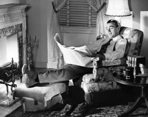 Mid adult man reading newspaper in armchair Poster Print - Item # VARSAL25536509