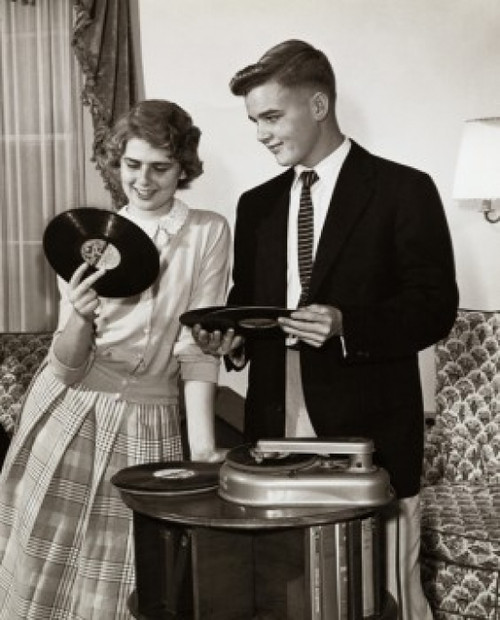 Young couple holding records near turntable Poster Print - Item # VARSAL2555826