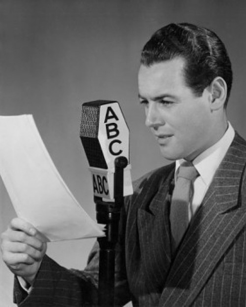 Mid adult man reading a report into a microphone Poster Print - Item # VARSAL2554487