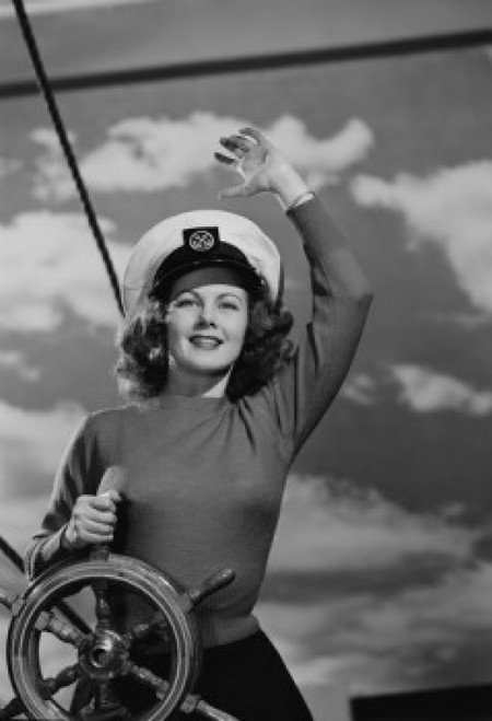 Woman wearing sailor hat at helm of ship Poster Print - Item # VARSAL255422890