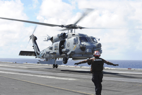 Pacific Ocean, June 23, 2014 - An MH-60R Sea Hawk helicopter lifts off the flight deck of the aircraft carrier USS Ronald Reagan for an aerial change of command ceremony. Poster Print - Item # VARPSTSTK108342M