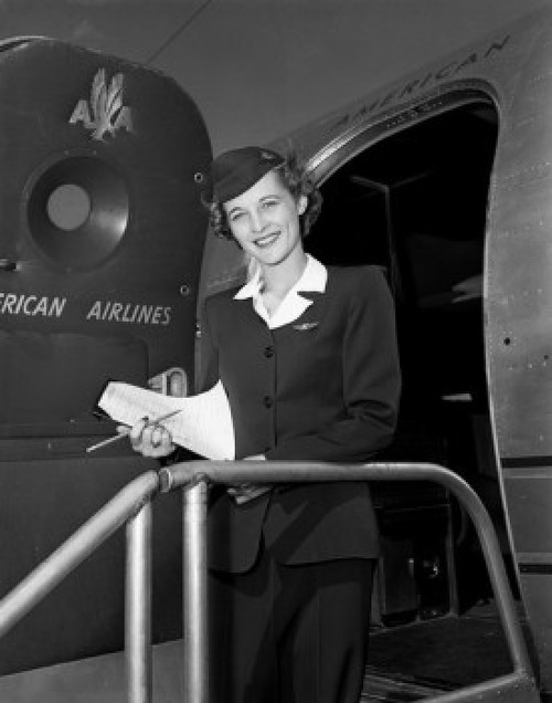 Young female flight attendant standing in aiplane door and smiling Poster Print - Item # VARSAL255417978