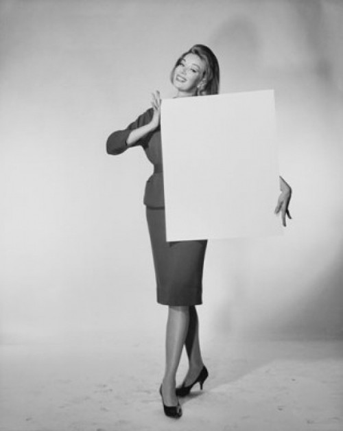 Portrait of a young woman holding a blank placard Poster Print - Item # VARSAL25541942