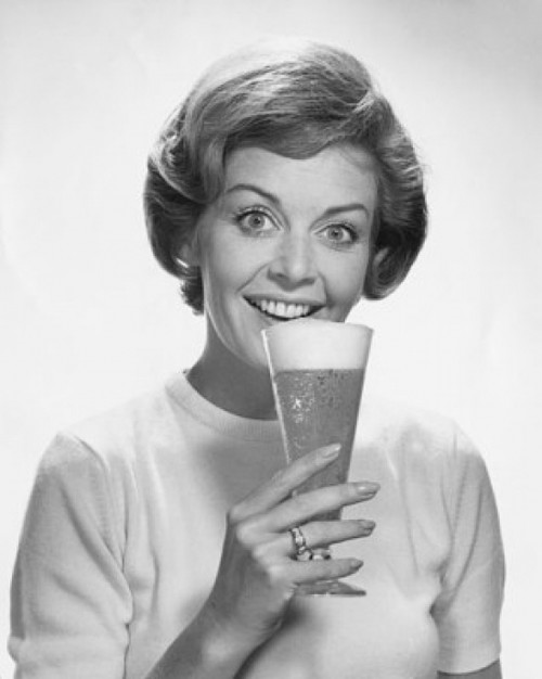 Portrait of young woman drinking beer Poster Print