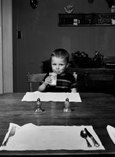 Boy sitting behind table drinking milk Poster Print - Item # VARSAL255416847