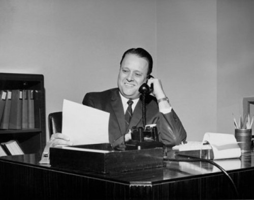 Mature businessman talking on telephone in office Poster Print - Item # VARSAL25548241