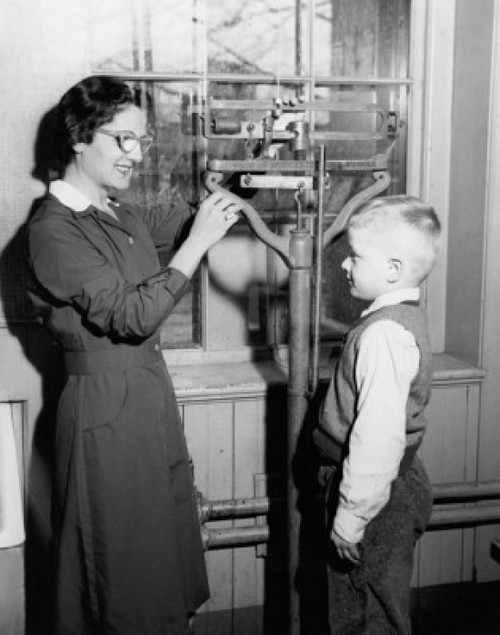 Side profile of a female pediatrician weighing a boy Poster Print - Item # VARSAL25515213