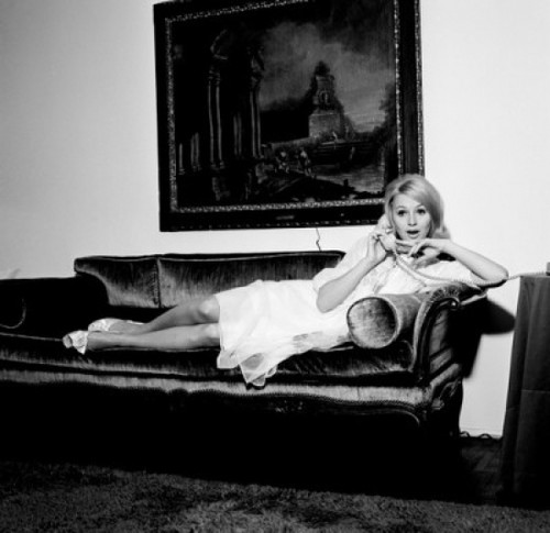 Young woman reclining on sofa  using telephone Poster Print - Item # VARSAL255417737