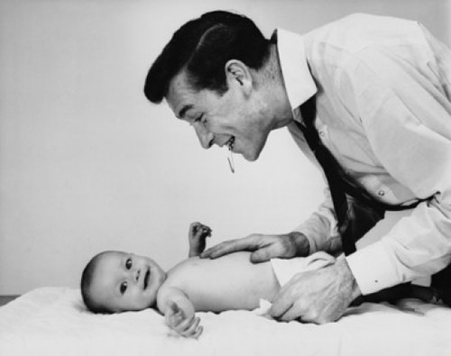 Mid adult man changing the diaper of his baby Poster Print - Item # VARSAL2559773A