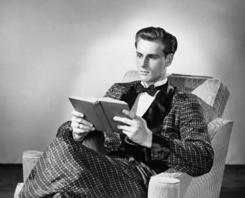 Young man sitting in an armchair and reading a book Poster Print - Item # VARSAL2555220