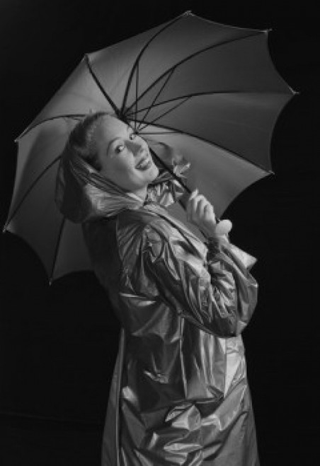 Young woman holding umbrella and wearing raincoat Poster Print - Item # VARSAL255422906A