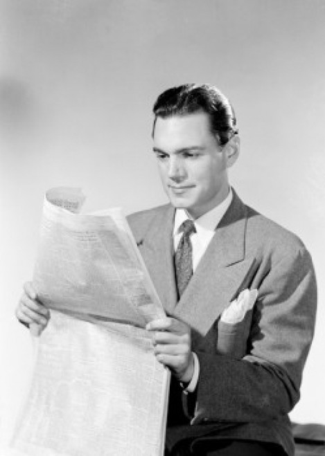 Young man reading newspaper Poster Print - Item # VARSAL255422923