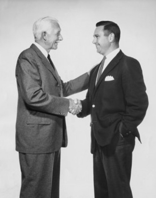 Two businessmen shaking hands Poster Print