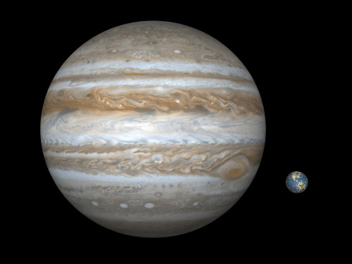 Artist's concept comparing the size of the gas giant Jupiter with that of the Earth Poster Print - Item # VARPSTWMY100032S