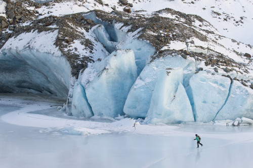 Woman Ice Skating In Front Of Saddlebag Glacier, Chugach Mountains Near Cordova, Southcentral Alaska, Winter Poster Print by Milo Burcham / Design Pics - Item # VARDPI2139790