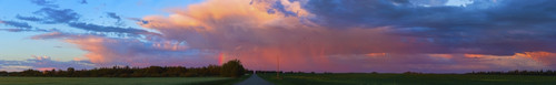 Glowing pink clouds over green fields and a country road at sunset; Alberta, Canada Poster Print by 770 Productions / Design Pics - Item # VARDPI12325131