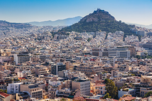 Athens, Attica, Greece. View over Athens from the Acropolis to 277 meter high Mount Lycabettus crowned by the Chapel of St. George. Poster Print by Panoramic Images - Item # VARPPI174269