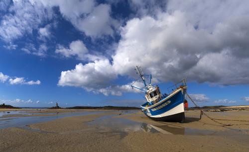 Fishing boat at beach against cloudy sky, Great Island, Cotes-d'Armor, Brittany, France Poster Print by Panoramic Images - Item # VARPPI172985