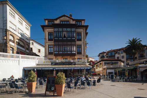 People at sidewalk cafe in town square, Comillas, Cantabria Province, Spain Poster Print by Panoramic Images - Item # VARPPI156722