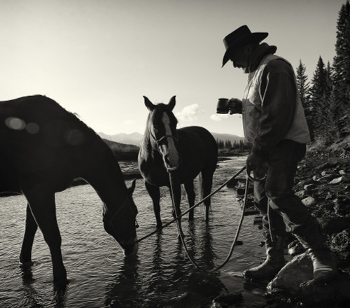 Cowboy having his morning coffee at the edge of a river with his horses, Ya-Ha-Tinda Ranch, Clearwater County; Alberta, Canada Poster Print by Deb Garside / Design Pics - Item # VARDPI12310980