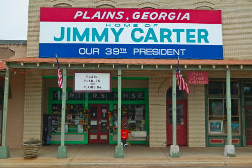 Storefront with banner exclaiming Plains Georgia to be the home of Jimmy Carter, our 39th President in Plains, Georgia Poster Print by Panoramic Images - Item # VARPPI181709