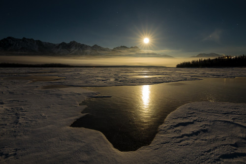 A full moon rises over the Chugach Mountains and the Knik River in South-central Alaska; Alaska, United States of America Poster Print by Ray Bulson / Design Pics - Item # VARDPI12321341