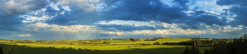 Clouds in a blue sky cast shadows on the lush, green fields below; Alberta, Canada Poster Print by 770 Productions / Design Pics - Item # VARDPI12325133