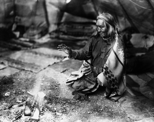 Navajo Man, C1915. /Na Navajo Man Warming His Hands Over A Fire In A Tepee. Photograph By William Carpenter, C1915. Poster Print by Granger Collection - Item # VARGRC0117184