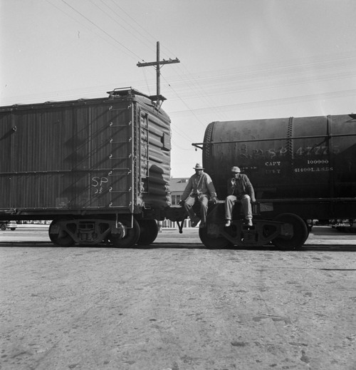 Railroad, 1937. /Nitinerant Men Riding Outside A Train Hauling Oil Tanks In Kingsbury, California.  Photograph By Dorothea Lange, 1938. Poster Print by Granger Collection - Item # VARGRC0526463