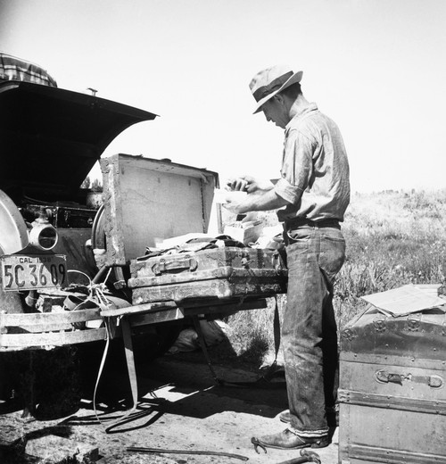 Migrant Worker, 1938. /Nmigrant Worker Sorting Luggage In San Joaquin Valley, California. Photograph, By Dorothea Lange, 1938 Poster Print by Granger Collection - Item # VARGRC0092886