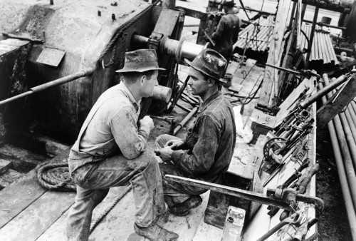 Oil Workers, 1939. /Noil Field Workers Talking At An Oil Well In Kilgore, Texas. Photograph By Russell Lee, April 1939. Poster Print by Granger Collection - Item # VARGRC0121628