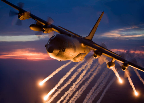 A C-130 Hercules releases flares during a mission over Kansas