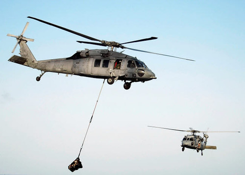 Helicopters carry munitions to the flight deck of aircraft carrier USS Abraham Lincoln Poster Print by Stocktrek Images - Item # VARPSTSTK101165M
