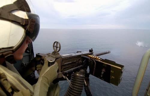 Aviation Warfare Systems Operator fires a 50 caliber machine gun out of an SH-60B helicopter Poster Print by Stocktrek Images - Item # VARPSTSTK100512M